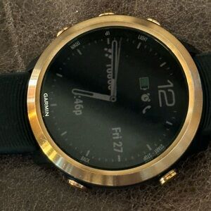 garmin black smartwatch with gold bezel